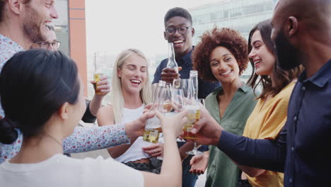 Creative-business-colleagues-celebrating-with-drinks-on-a-balcony-in-the-city-after-work,-close-up