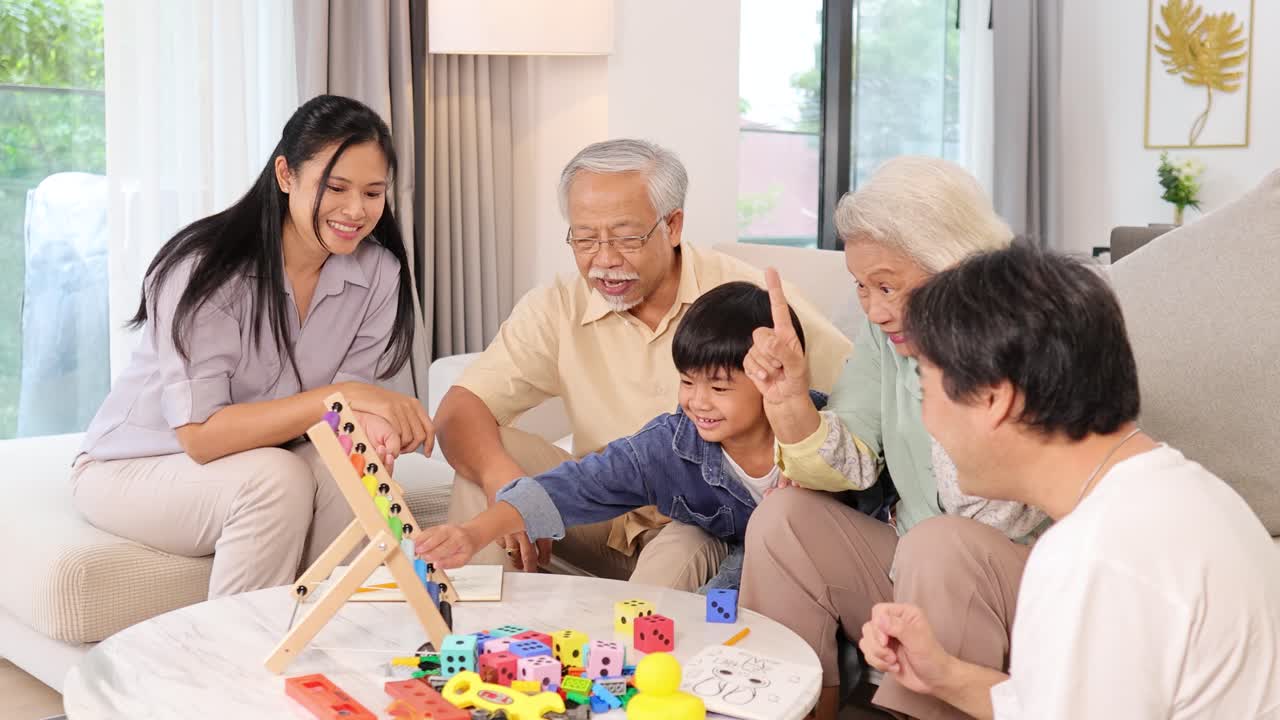 A joyful Asian family plays a game in a bright, cozy living room, fostering connection and laughter