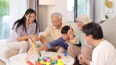 a joyful asian family plays a game in a bright, cozy living room, fostering connection and laughter
