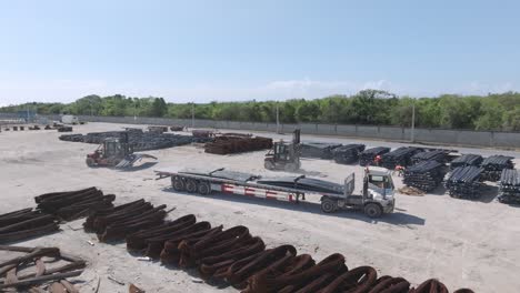 Forklift-loading-steel-in-outdoor-work-area