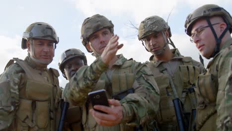 front view of military soldiers using mobile phone during training 4k