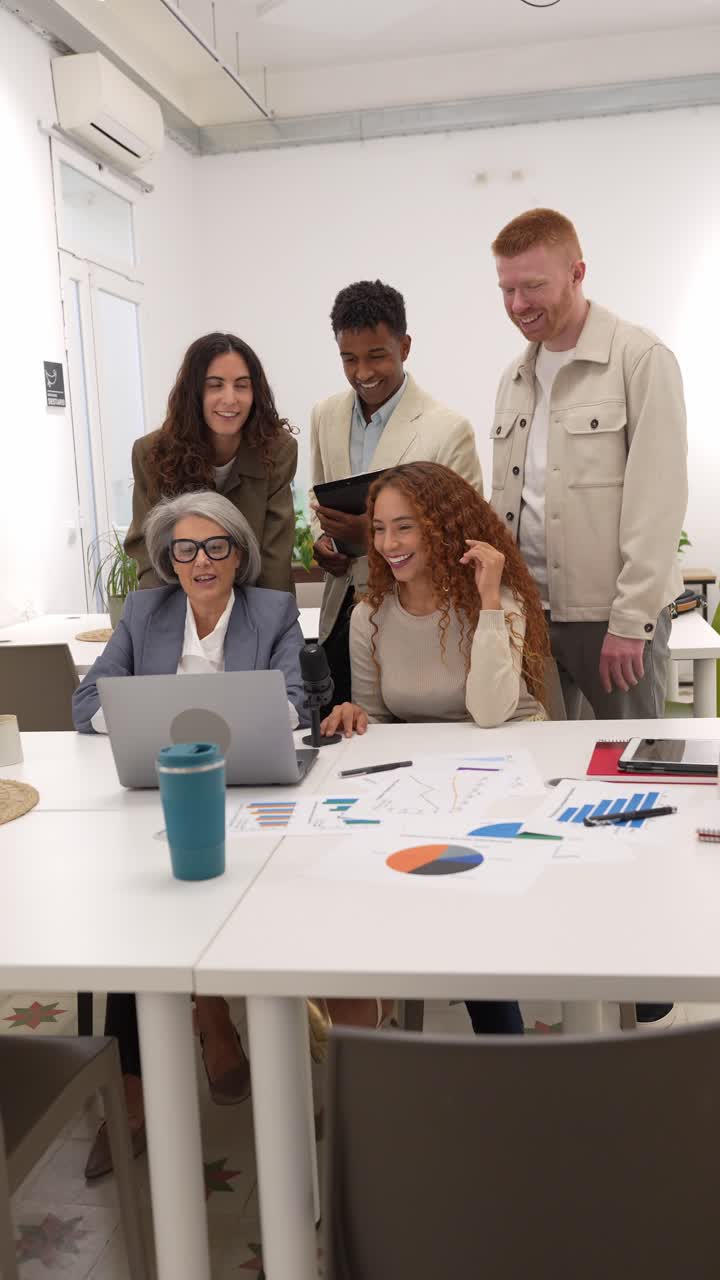 Diverse Business Team Collaborating on Laptop in Modern Office