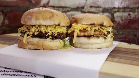 Tilt-up-focus-pull-medium-shot-of-beef-and-chicken-burgers