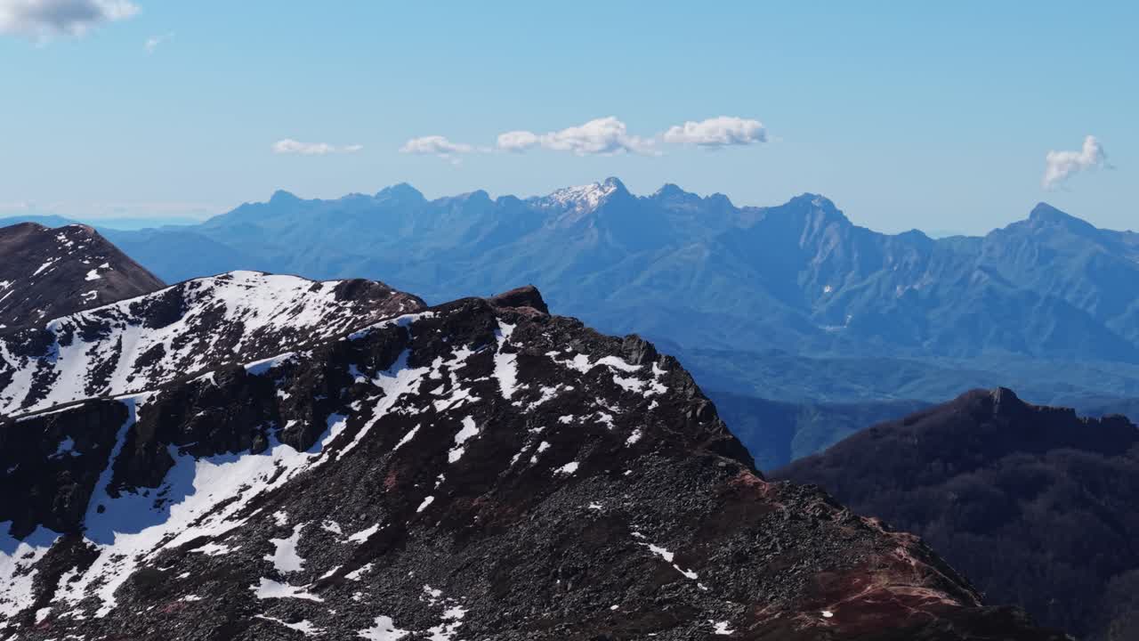 Stunning Dolomites mountain landscape, rocky slopes with patches of snow and distant peaks