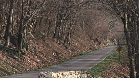 Medium-Shot-Of-A-Car-Driving-Down-The-Blue-Ridge-Highway