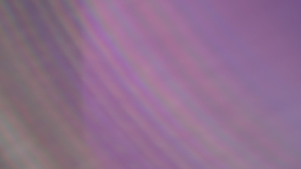 Moving abstract lens flares and light leaks on black background