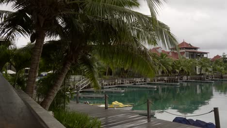 seychelles eden island, villas with coconut palm trees, calm sea water