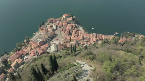 medieval castle on lake como in italy, from a drone