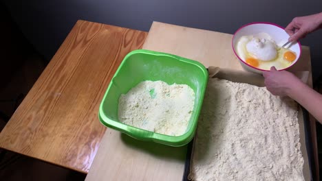 Chef-Preparing-Flour-In-A-Baking-Pan-And-Mix-Apple-Batter-With-Eggs-In-A-Bowl