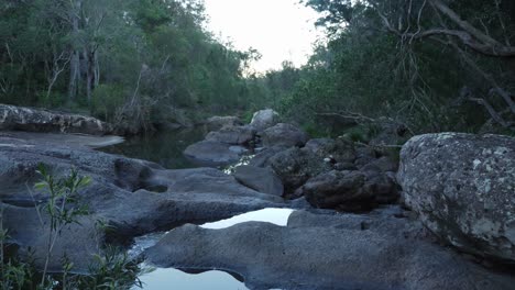 fresh water flowing on the rocky river deep in the forest - mount byron, queensland, australia