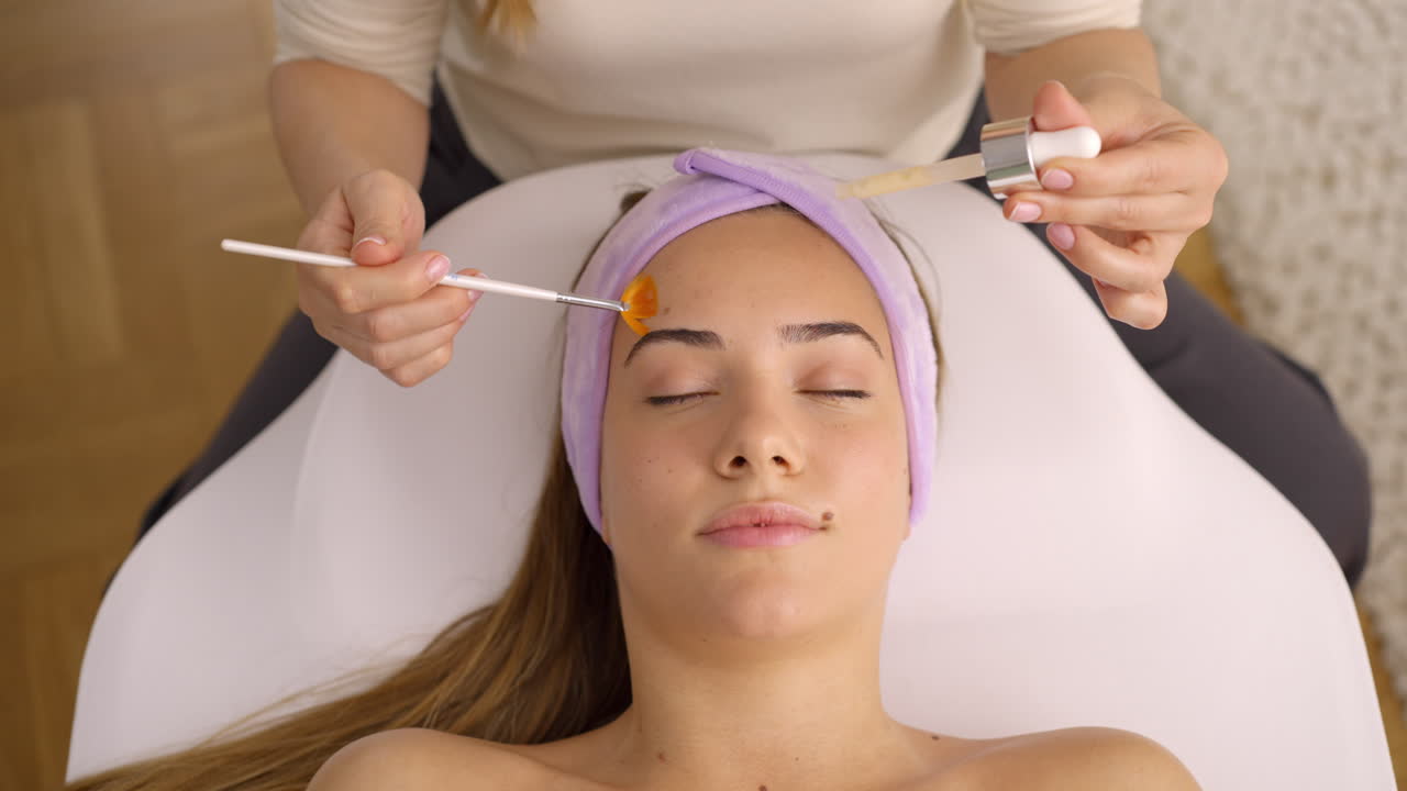 Woman receiving facial beauty treatment