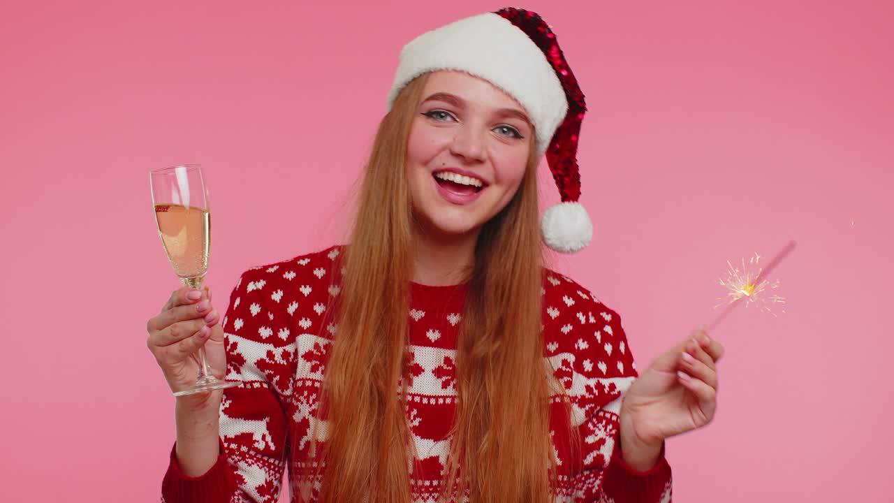 Christmas girl dancing with bengal sparklers fireworks and champagne sending wishes congratulation