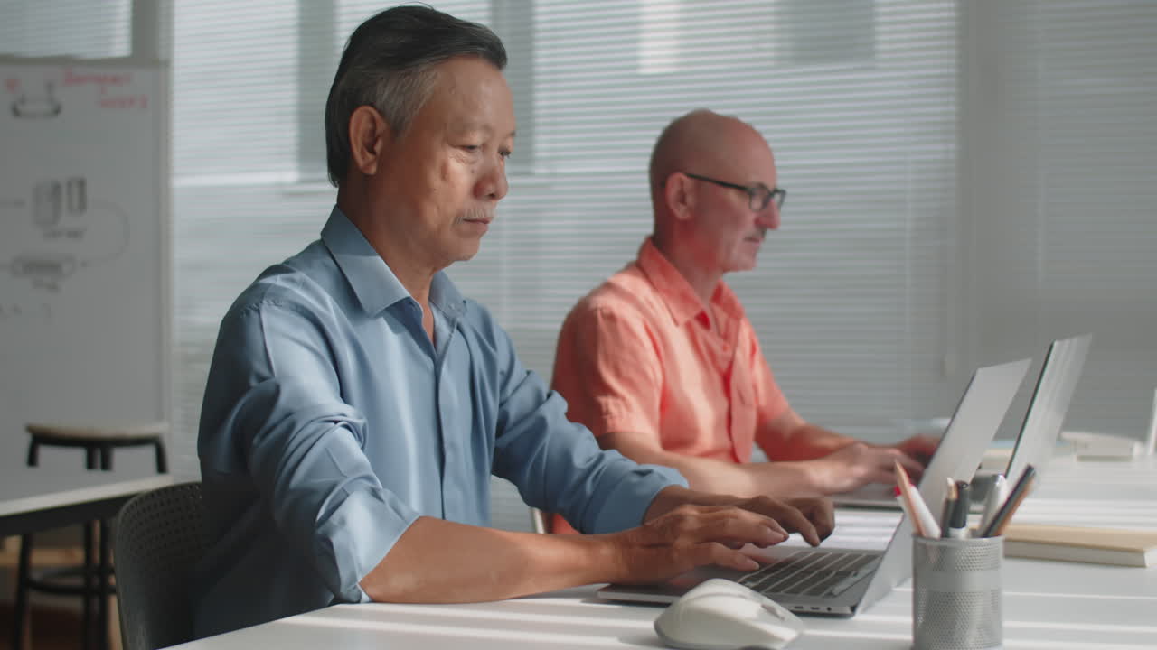 Aged Men Using Laptops during Computer Class