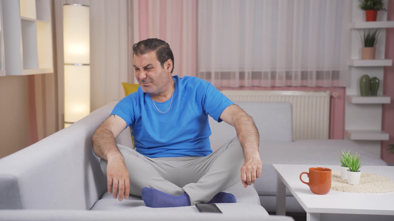 The man who smells bad odor is disturbed and disgusted.