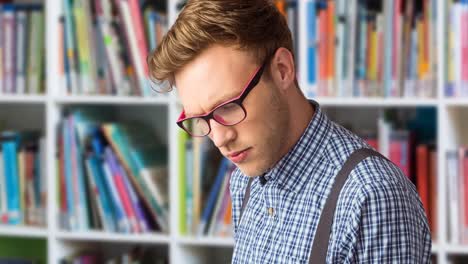 Animation-of-caucasian-man-reading-book-over-library