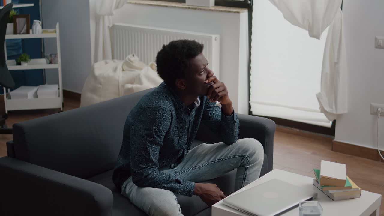 Portrait of pensive thoughtful african american man looking out the window
