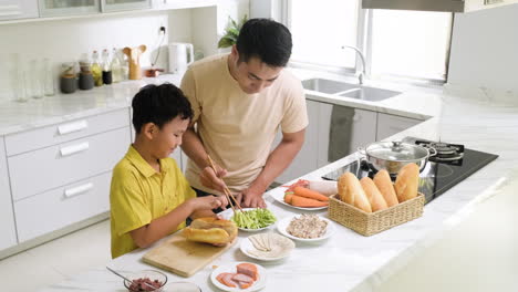 asian man and boy in the kitchen