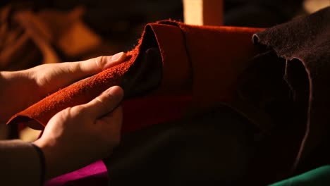 hands examining various leather pieces
