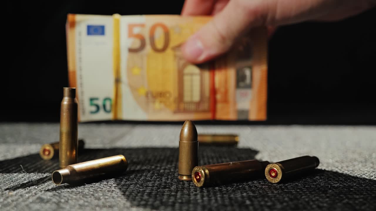 Cash and live round taken away leaving shell casings on dark surface