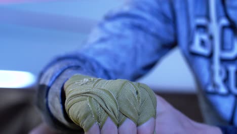 person wrapping boxing hand wraps