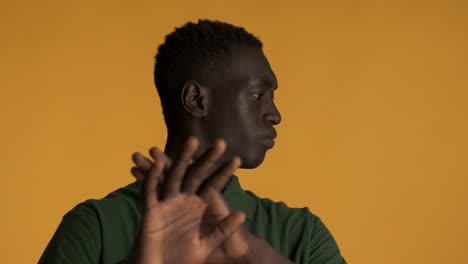 disgusted african american man on yellow background.