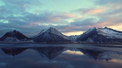 snowy mountains against sundown sky