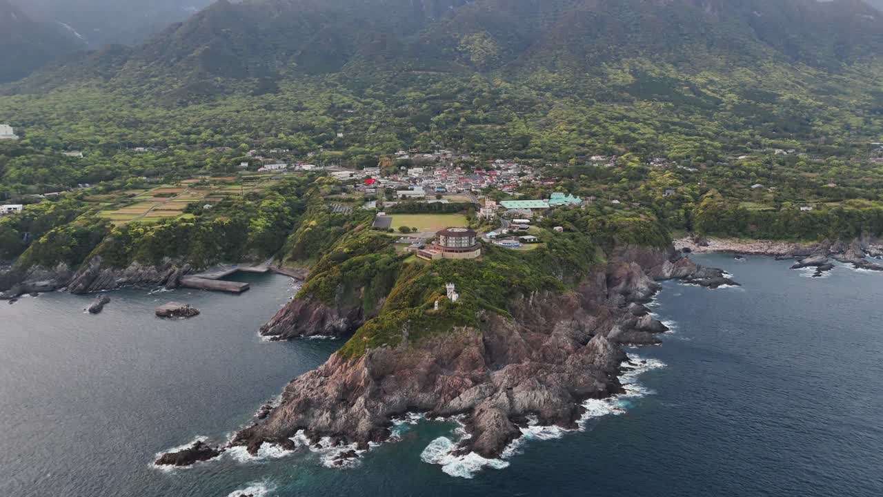 Coastal aerial view with mountains and town