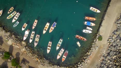 Birds-eye-view-of-a-group-of-small-fishing-boats-tied-in-a-small-marina