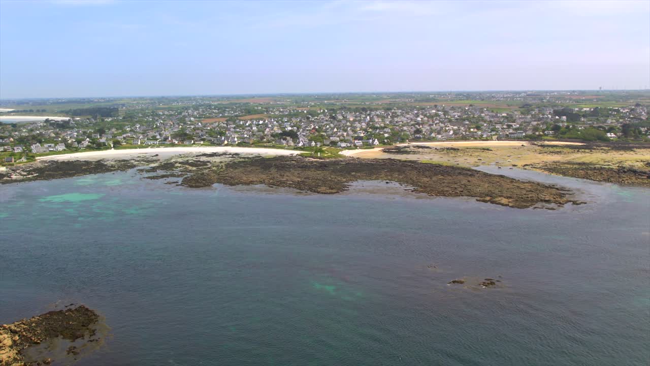 Aerial view of Brittany’s coastline near Brest, showcasing rocky shores, sandy beaches, and a coastal village. Ideal for travel and tourism, emphasizing Brittany’s unique seascape and scenic views.