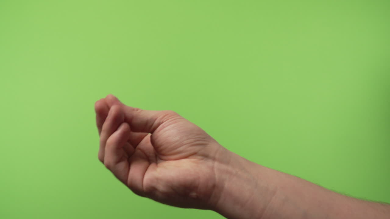 three hand gestures in front of chroma green screen. Adult hand showing thumbs up, all good gesture and italian hand gesture