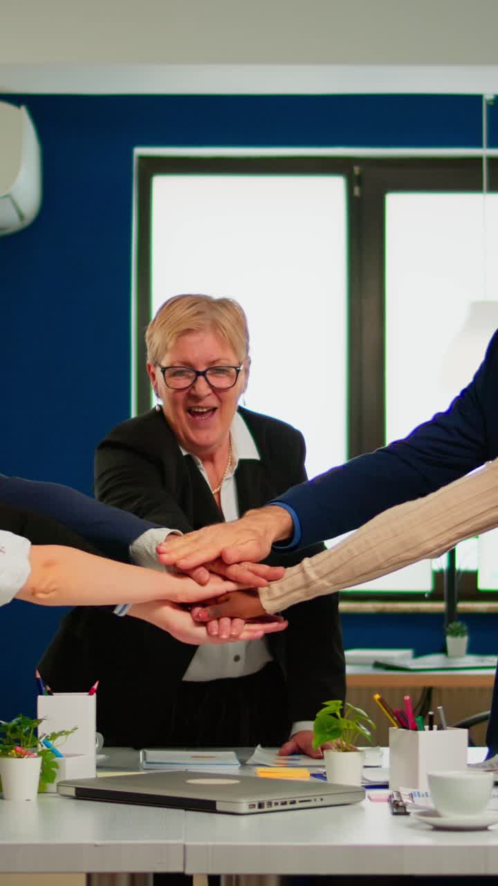 Vertical video Happy diverse colleagues with new business opportunity enjoing victory