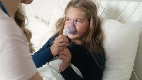 pediatrician giving nebulizer to an ill child at home