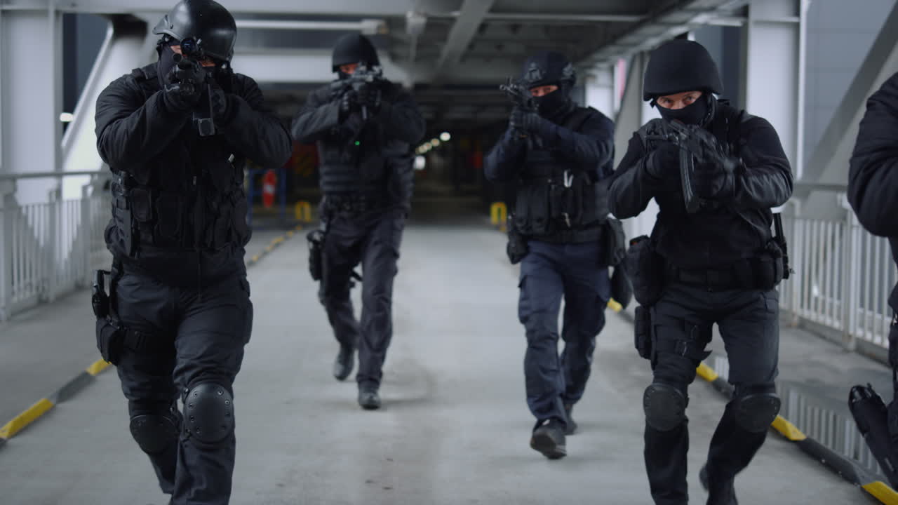 Special forces team moving on bridge. Special ops police team in action