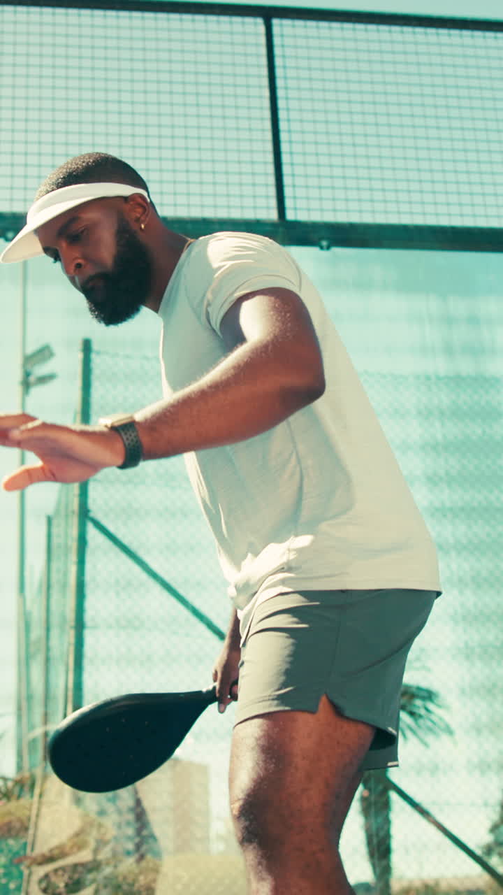 A man with a beard wearing a cap and t-shirt