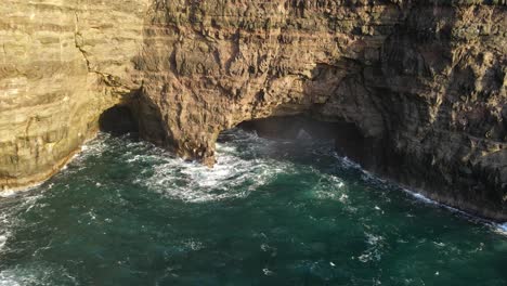 Drone-footage-of-caves,-cliffs-and-the-Leitisvatn-Lake,-aka-the-Floating-Lake,-on-the-Vagar-island-in-the-Faroe-Islands