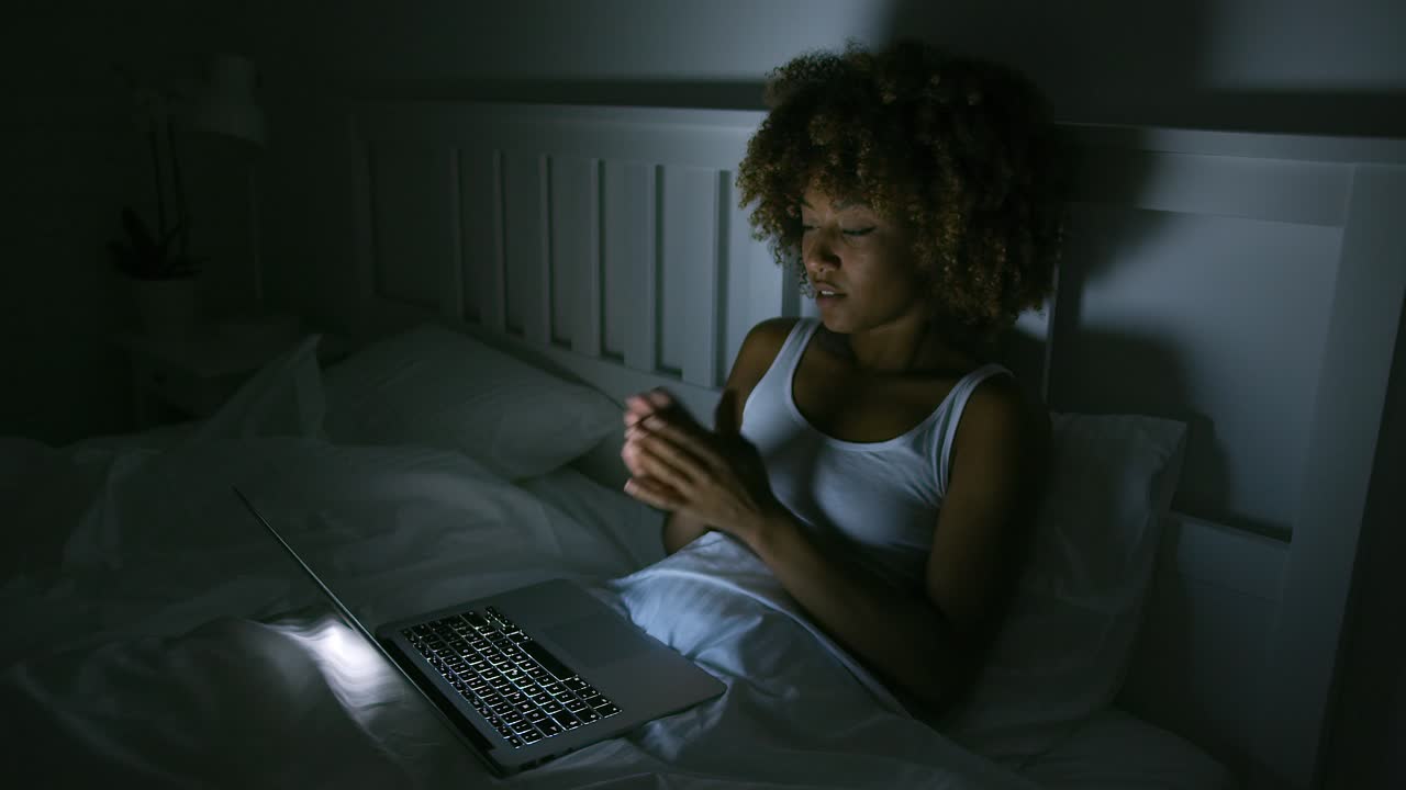 Young woman using laptop in night