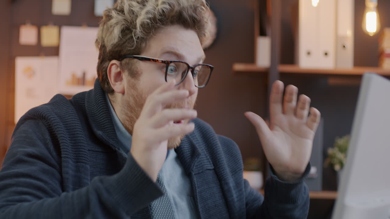 Surprised Man Adjusting Glasses in Office