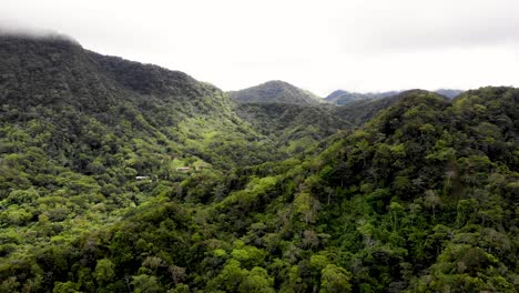 Extinct-volcano-wall-hills-in-Valle-de-Anton-central-Panama-with-low-moisture-clouds,-Aerial-dolly-out-shot