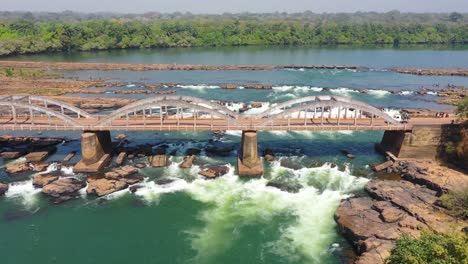 Aerial-Over-A-Man-Climbing-On-The-Saltinho-Bridge-Over-The-Corumbal-River-In-Guineabissau-West-Africa-2