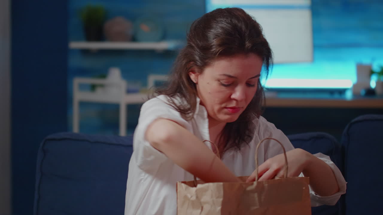 Young adult with face mask getting meal delivered at home