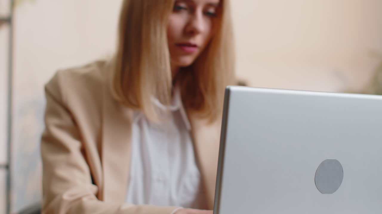 Business woman freelancer at office workplace desk working on laptop computer sends online messages