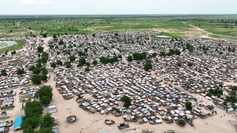 Aerial---Descending-shot-over-vast-refugee-settlement-in-Niger-on-sunny-day