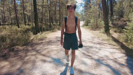 total wide front shot young shirtless teenage walking in forest in fontainebleau