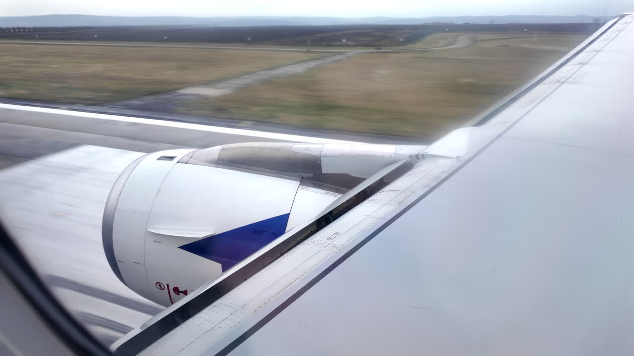View from an airplane window of an airplane landing at the airport