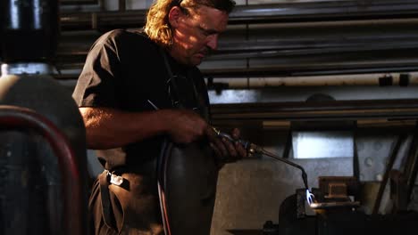 welder using welding torch