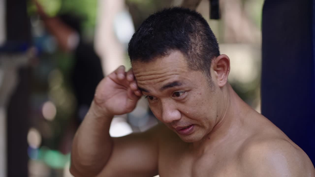 Man wiping sweat during a workout