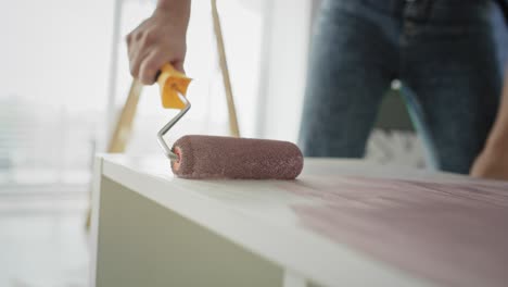 tracking video of painting old furnitures with a roller