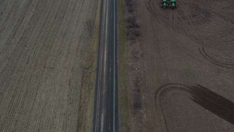 country road and farm land with storm in horizon