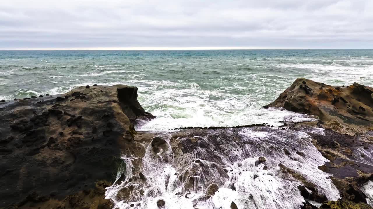 Waves crash into a rocky embankment