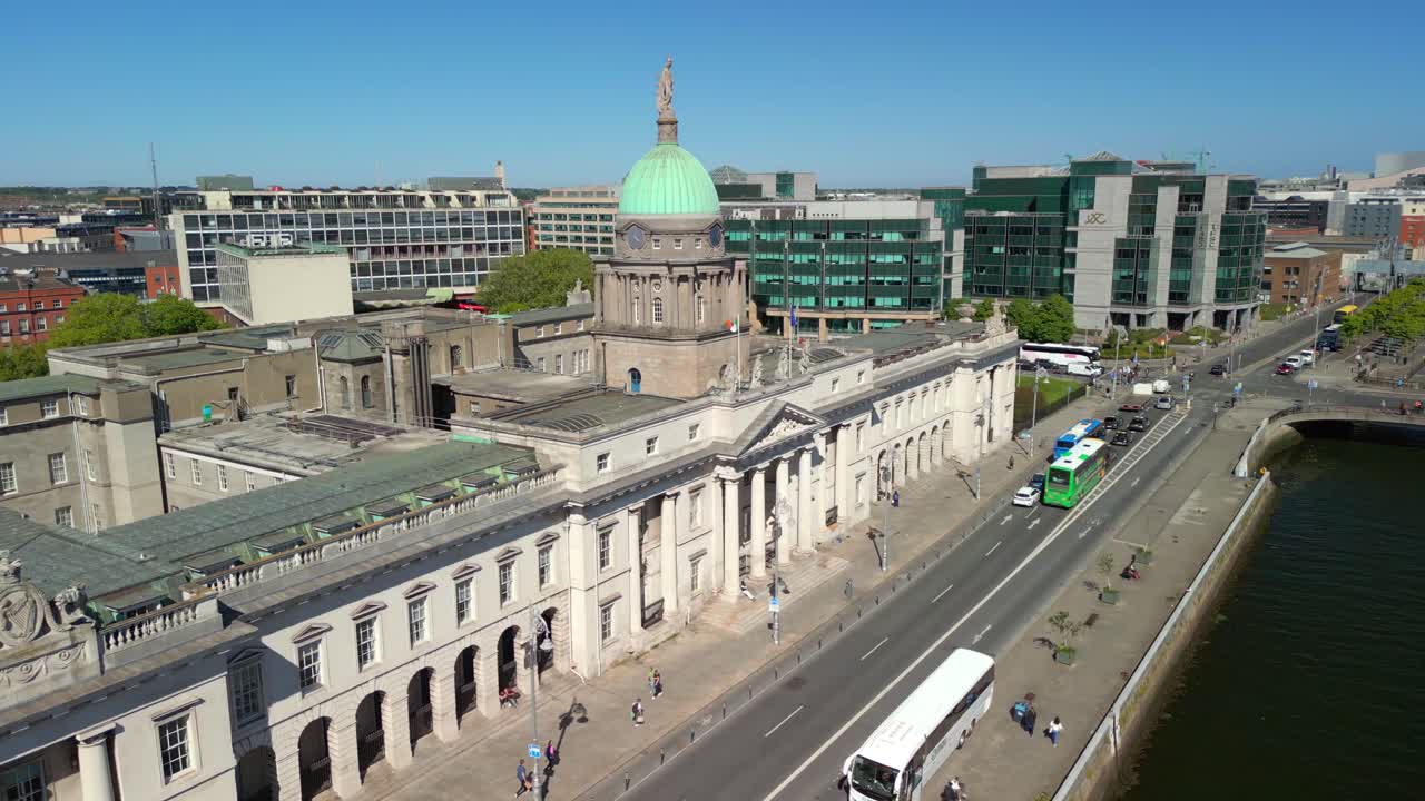 Ascending aerial video of Custom House Quay in Dublin, County Leinster, Ireland on a bright and sunny day. Filmed in 4K, 60FPS and with Rec709 color.